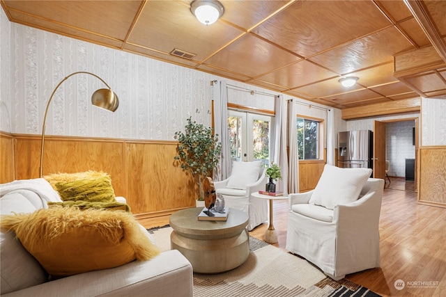 sitting room with wooden ceiling, hardwood / wood-style floors, and french doors