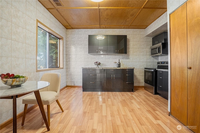 kitchen featuring tile walls, light wood-type flooring, light stone counters, wood ceiling, and stainless steel appliances