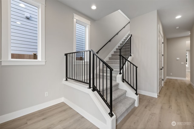 stairway with hardwood / wood-style flooring