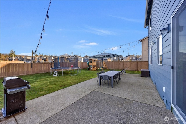 view of patio featuring a playground and a trampoline