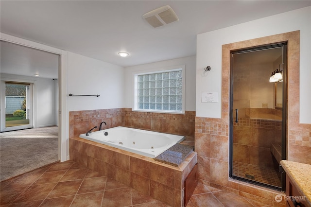 bathroom featuring separate shower and tub, tile patterned flooring, and vanity