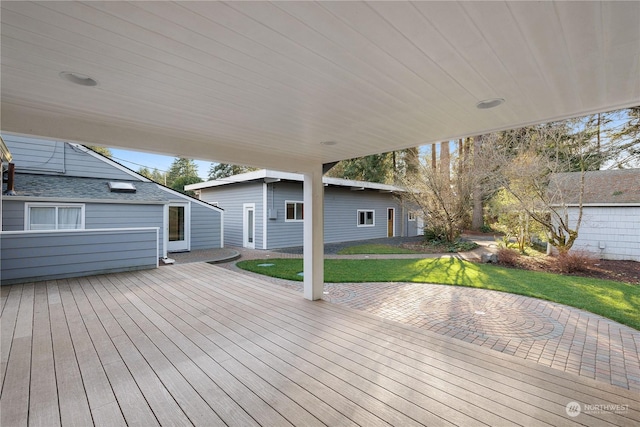 deck featuring an outbuilding, a yard, and a patio