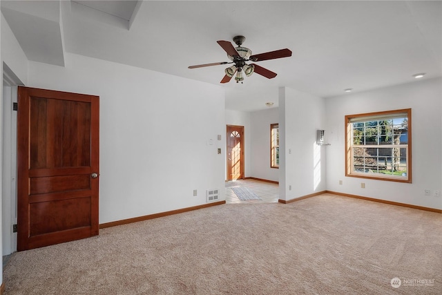 spare room featuring ceiling fan and light colored carpet