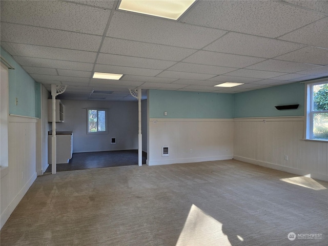 basement featuring carpet flooring and a drop ceiling