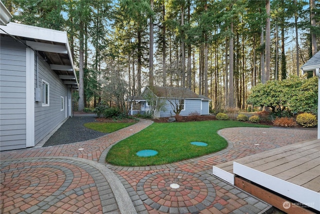 view of yard featuring an outdoor structure and a patio