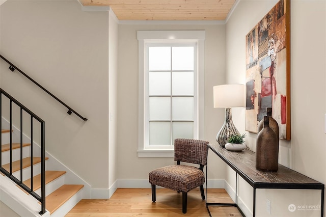 interior space featuring hardwood / wood-style flooring, wooden ceiling, and crown molding