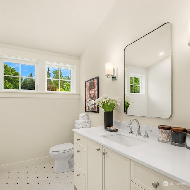 bathroom featuring toilet, vanity, and tile patterned flooring