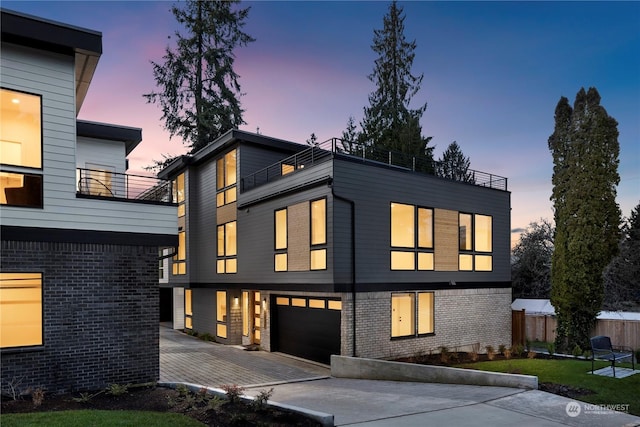 contemporary home featuring a balcony and a garage