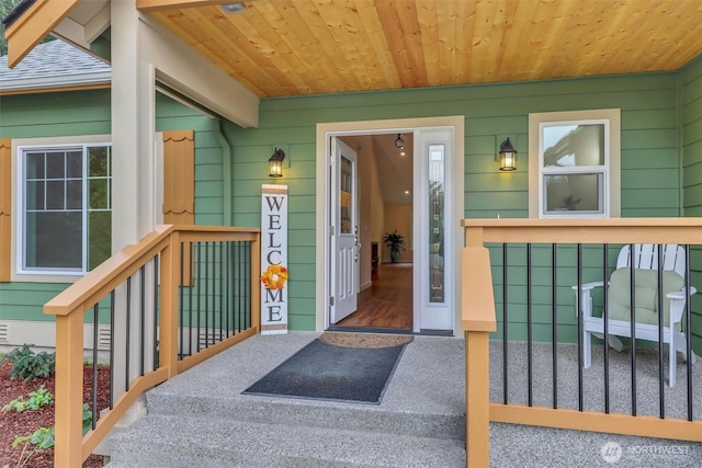 view of exterior entry featuring roof with shingles