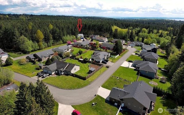 bird's eye view featuring a residential view and a forest view