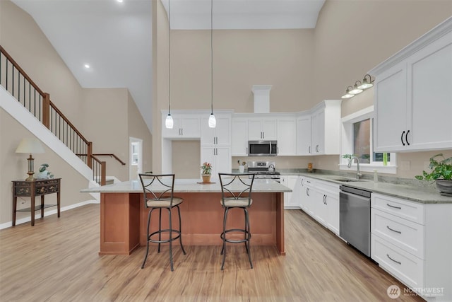 kitchen featuring white cabinetry, stainless steel appliances, and a center island