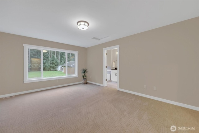 empty room with light carpet, visible vents, and baseboards