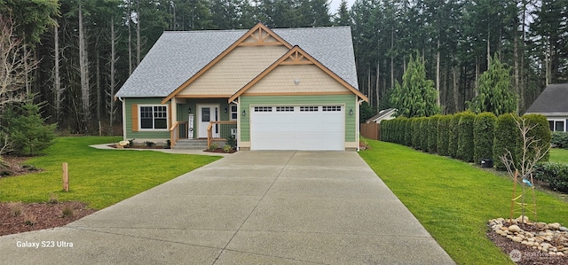 craftsman inspired home featuring a front yard, roof with shingles, driveway, and an attached garage