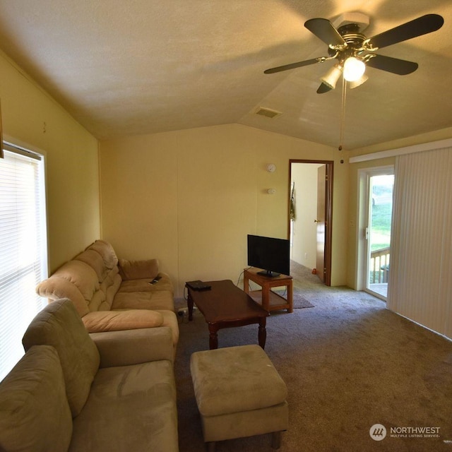 living room with ceiling fan, lofted ceiling, and carpet