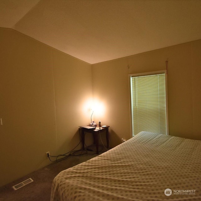 bedroom with carpet flooring and vaulted ceiling