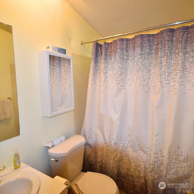 bathroom featuring tile walls, toilet, a textured ceiling, and a shower with shower curtain