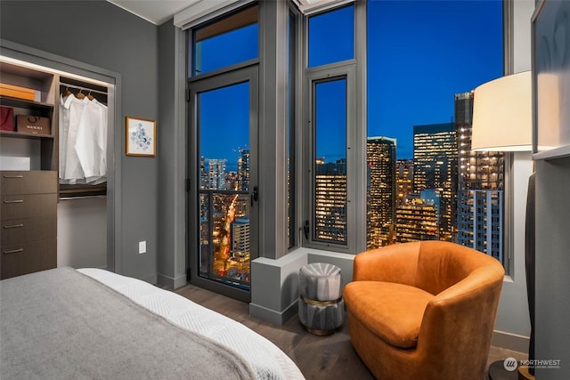 bedroom with dark wood-type flooring and a closet