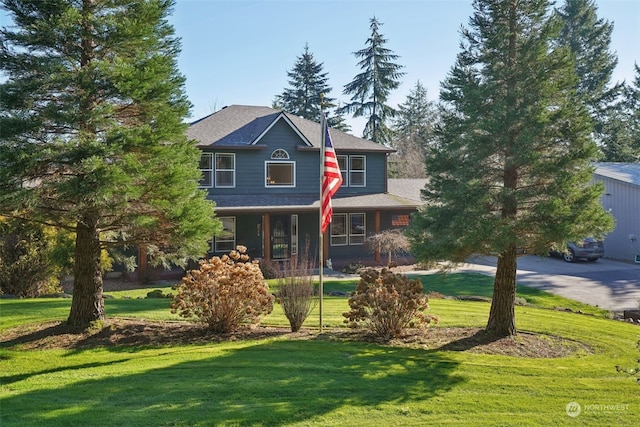 view of front of property with a porch and a front yard