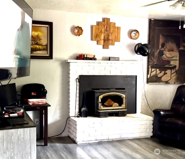 sitting room with hardwood / wood-style flooring, a textured ceiling, and ceiling fan