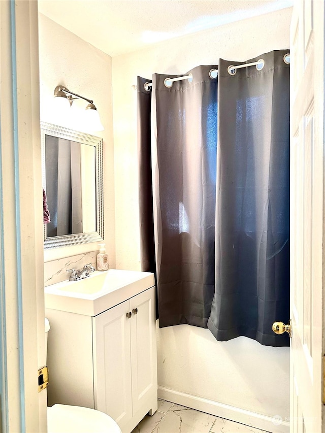 bathroom with toilet and vanity