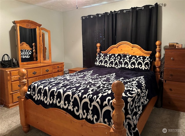 carpeted bedroom featuring a textured ceiling