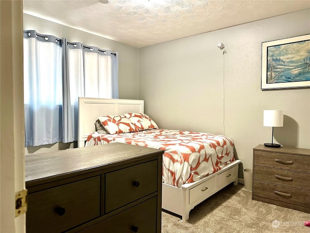 carpeted bedroom featuring a textured ceiling