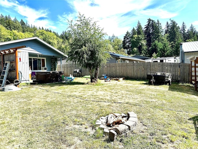 view of yard with an outdoor fire pit and a hot tub