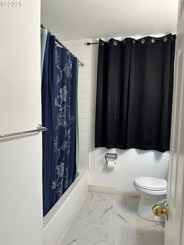 bathroom with shower / bath combo with shower curtain and toilet