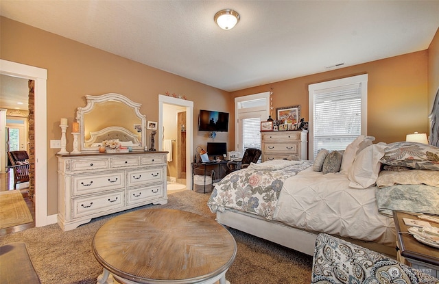 carpeted bedroom featuring ensuite bathroom