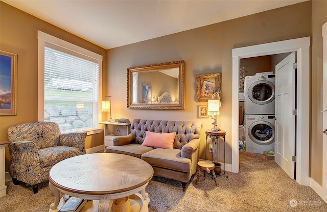 sitting room with carpet floors, a healthy amount of sunlight, and stacked washing maching and dryer