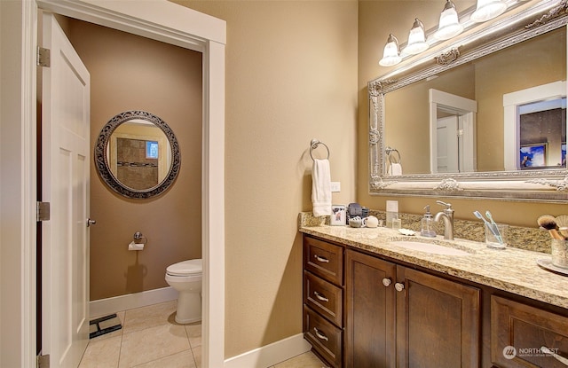 bathroom featuring tile patterned floors, toilet, and vanity