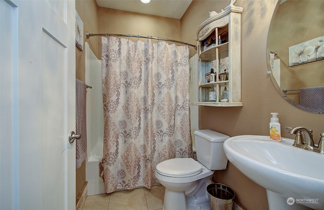 full bathroom featuring shower / bathtub combination with curtain, tile patterned floors, toilet, and sink