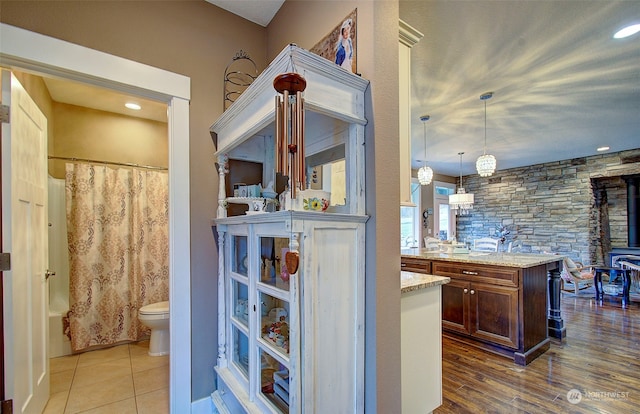 full bathroom featuring vanity, hardwood / wood-style flooring, toilet, and shower / bath combo