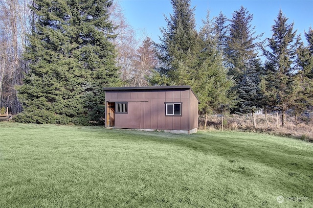 view of outbuilding with a lawn