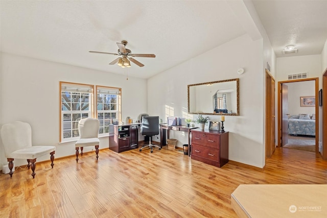 office area with light hardwood / wood-style floors and ceiling fan