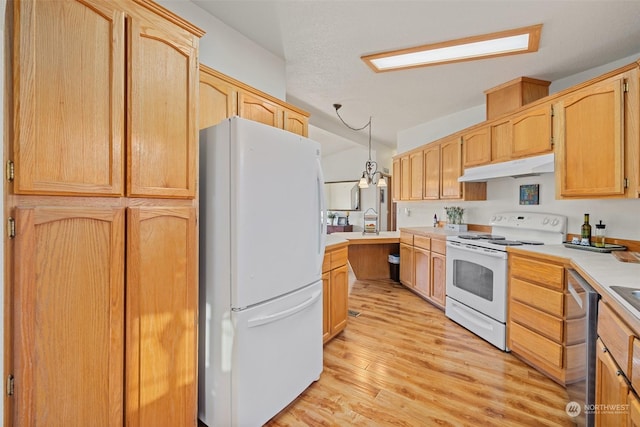 kitchen with light hardwood / wood-style floors, white appliances, light brown cabinets, and hanging light fixtures