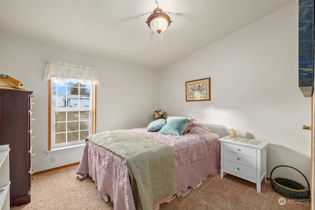 bedroom with light carpet and lofted ceiling