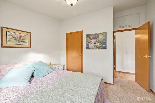 bedroom featuring light carpet