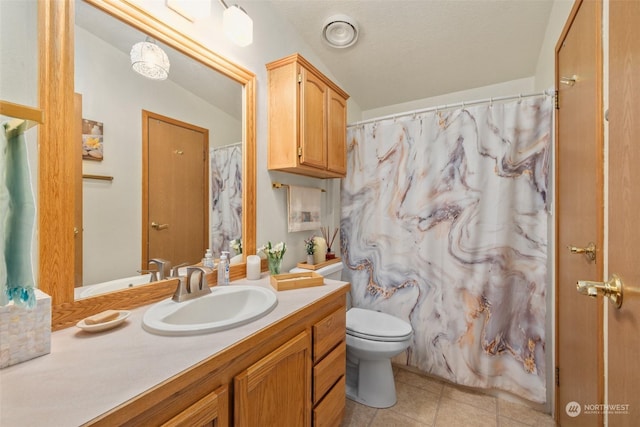 bathroom with toilet, vanity, and vaulted ceiling