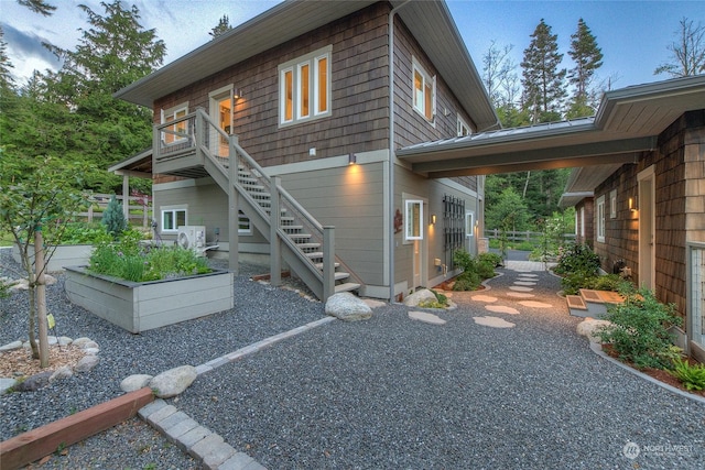 rear view of property with stairs and fence