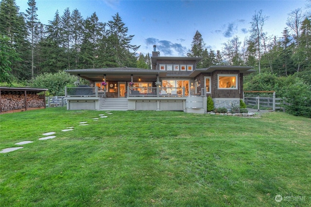 back of house with a yard, fence, and a chimney