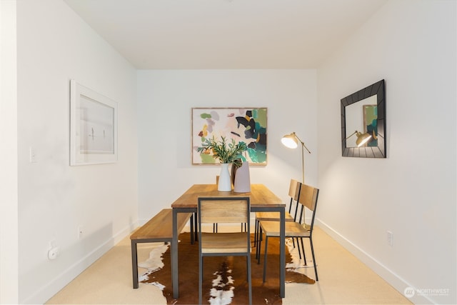 dining space with carpet flooring