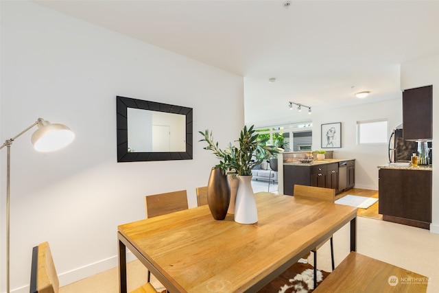 dining room featuring sink and rail lighting