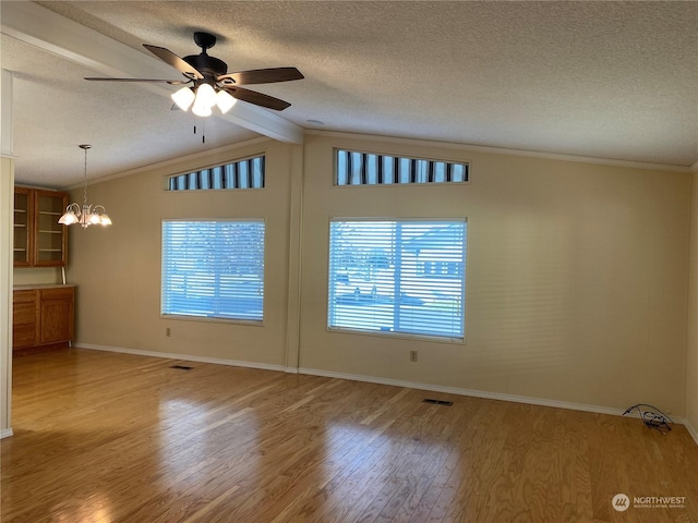 empty room featuring crown molding, vaulted ceiling with beams, wood-type flooring, a textured ceiling, and ceiling fan with notable chandelier