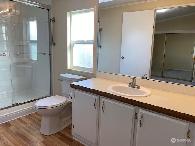 bathroom with hardwood / wood-style floors, vanity, walk in shower, toilet, and crown molding