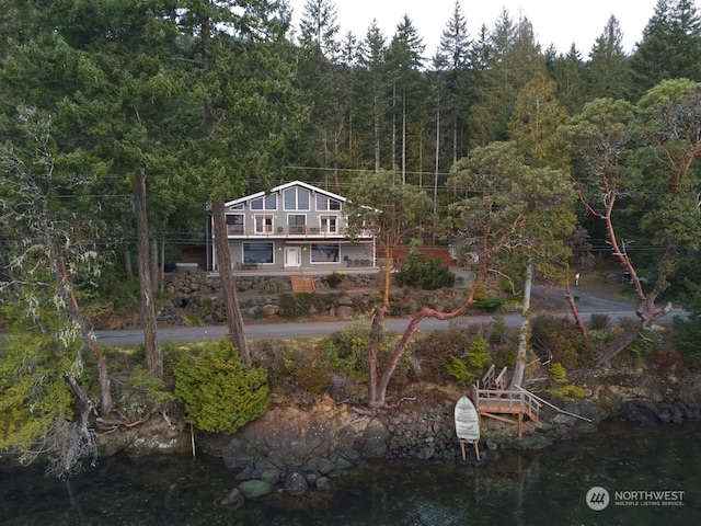 rear view of property featuring a water view