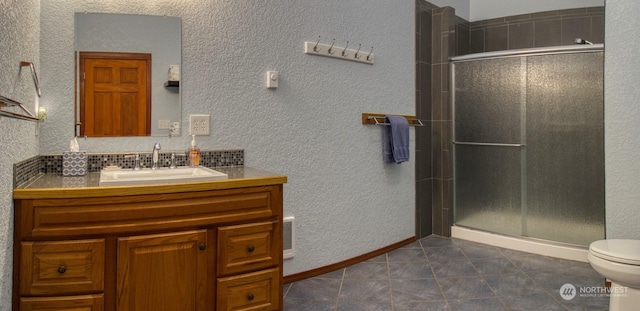 bathroom featuring vanity, an enclosed shower, tile patterned floors, and toilet