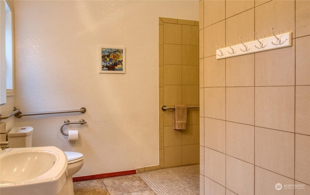 bathroom featuring tile patterned flooring, sink, and toilet