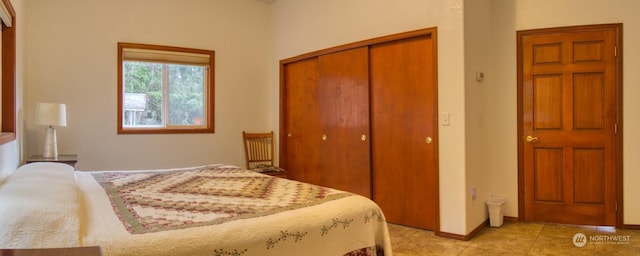 bedroom featuring light tile patterned flooring and a closet