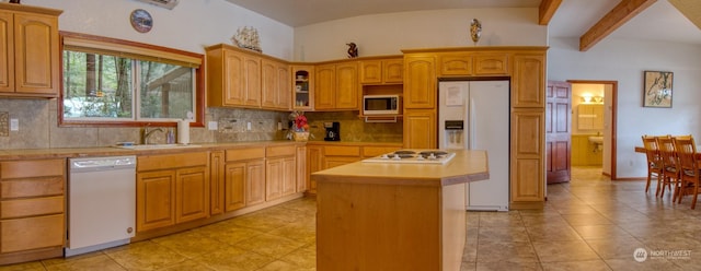 kitchen featuring tasteful backsplash, sink, white appliances, and a kitchen island